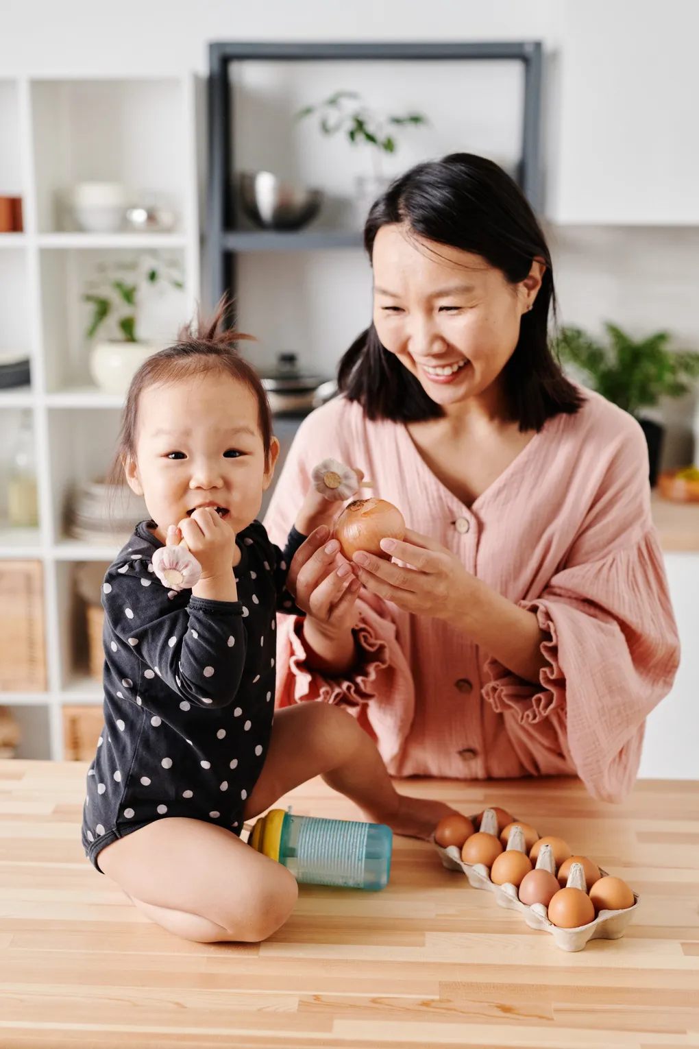 pexels-photo-7705357-1530h A woman and child are playing with eggs.